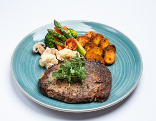 A juicy, perfectly cooked steak with a side of roasted vegetables.